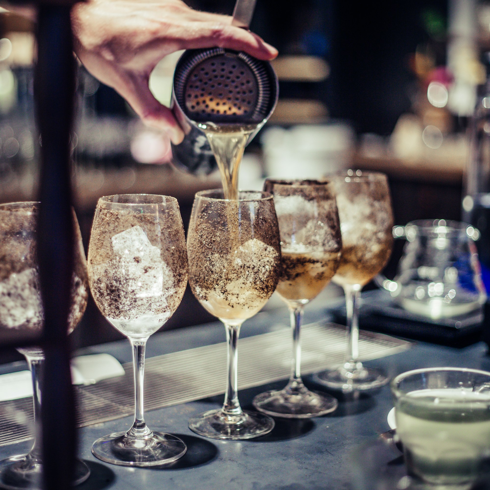 Bartender making an alcoholic cocktail, a summer cocktail in the bar