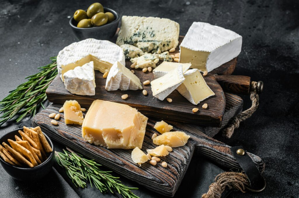 Delicious Cheese board. Assortment of cheese, camembert, brie, Gorgonzola, parmesan, olives