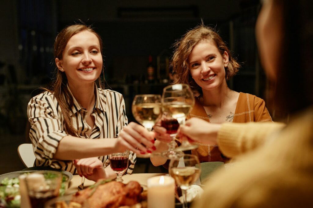 Girls toasting with wine at party