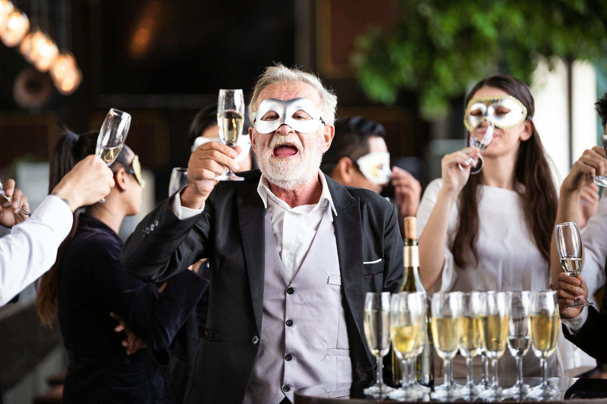 Group of office worker in fancy mask having celebration party.